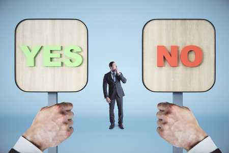 Businessman and hands holding yes and no wooden sign. Business and choice conceptの写真素材
