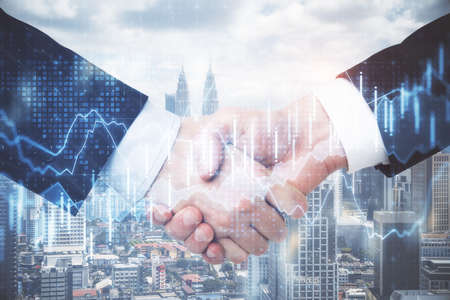 Businesspeople handshaking and glowing financial chart on panoramic city background. Occupation and...