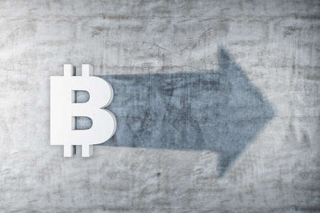 White bitcoin symbol with shadow in form arrow on concrete wall. Cryptocurrency and payment concept....