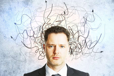 Businessman with drawn arrows over her head on concrete wall. Leadership and way concept. Close up
