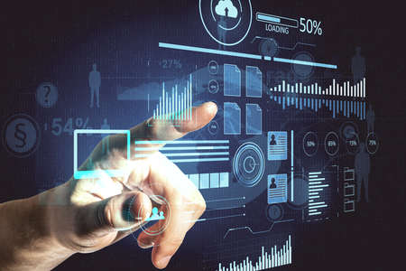 Hand using virtual screen with business charts and stock data. Business trading concept. Close up