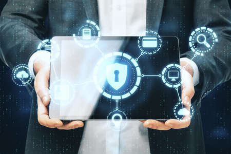 Businesswoman holding tablet with digital antivirus interface. Hacking and cyber attack concept....
