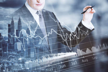 Businessman drawing business report hologram. Business and financial success concept. Close up