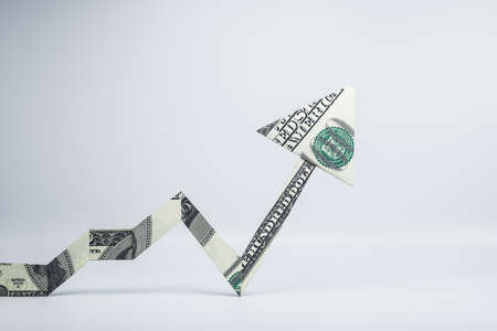 Arrow made of dollars on white background. Success and startup concept. 3D Renderingの写真素材