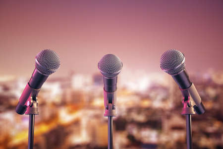 Three microphone on stage on a night city background. Art and performance concept. 3D Rendering