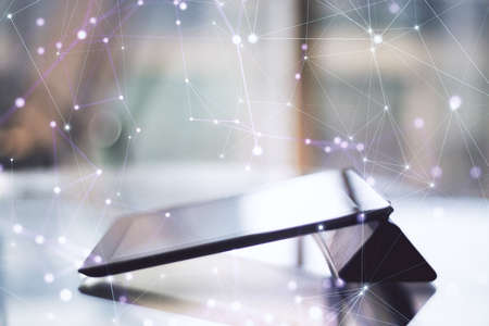 Desktop and digital tablet with abstract polygonal hologram. Big data and technology concept....