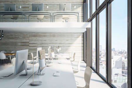Contemporary office hall with panoramic city view and computers on table. Workplace and company...