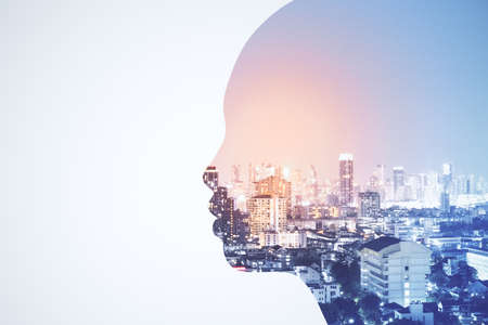 Close up of abstract human face on blurry city background. Architecture and robotics concept. 3D Renderingの写真素材
