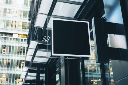 Black square signboard with blank space for your logo on the wall of a modern shopping center, mockupの写真素材