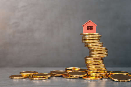 Red house on golden coins heap in concrete interior. Finance and real estate concept. 3D Renderingの写真素材