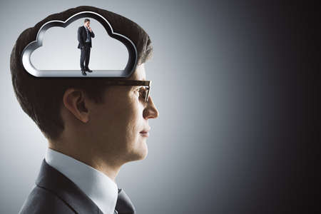 Silhouette of the brain in the head of with businessman on gray background. Artificial intelligence...