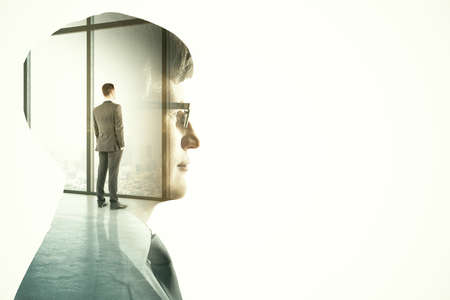 Businessman standing inoffice on skyscraper background. Teamwork and communication concept. Multiexposureの写真素材