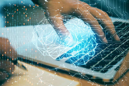 Hands using laptop with polygonal brain interface. Artificial intelligence and technology concept....