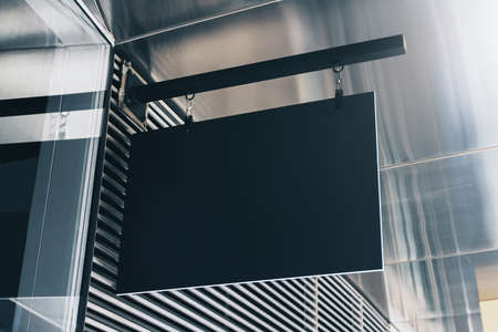 Black rectangular sign on the wall of a modern shopping mall, mock upの写真素材