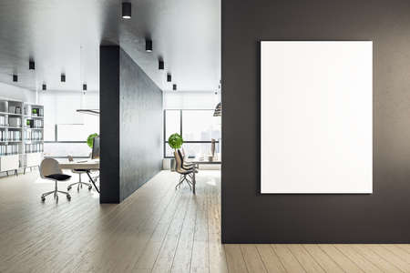 Modern workplace interior with computer and blank vertical poster on wall. Workplace and company concept. Mock up. 3D Renderingの写真素材