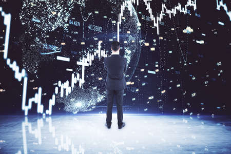 Businessman looking on glowing forex charts on big digital screen. Trade and stats concept. Double...
