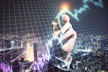 Hand drawing growing stock chart with digital grid on night city background. Trade and investment...