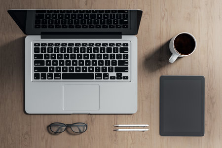 Top view of creative wooden designer desktop with laptop, coffee cup, tablet, notepad and other items. Mock up, 3D Renderingの写真素材