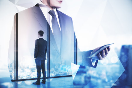 Businessman using digital tablet computer and looking in window on skyscraper background. Teamwork and communication concept. Multiexposureの写真素材