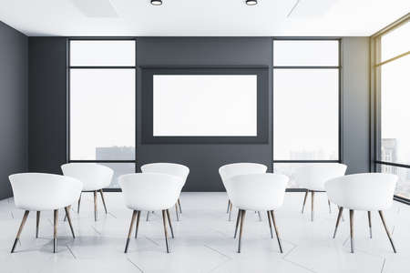 Empty white screen in modern presentation room with chairs and laptop on table. Conference and presentation concept. Mock up. 3D Renderingの写真素材