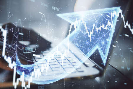 Businessman hands typing on keyboard laptop with business chart and polygonal arrow hologram....