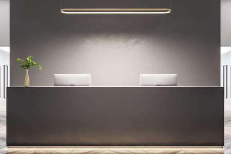 Stylish office lobby with gray concrete reception desk and two computers. Lifestyle and workplace...