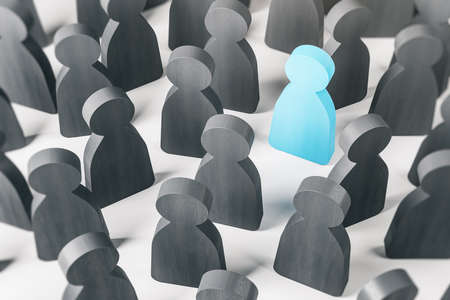 Blue wooden figure of a man as healthy man stands among lots of gray wooden figures. Coronavirus pandemic COVID-19. Quarantine and self isolation concept. 3D renderingの写真素材