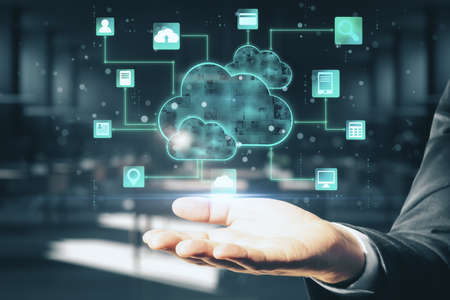 Cloud computing concept with digital screen with glowing cloud and application icons above man hand...