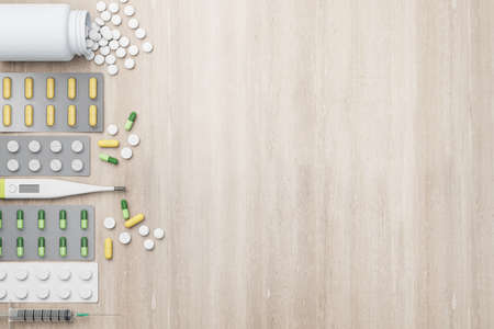 Blank wooden mockup background with variety of pharmaceutical medicine pills, tablets, capsules and thermometer placed leftwards. Medication concept. Mockup. 3D renderingの写真素材
