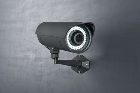Black outdoor security CCTV videocam on concrete wall outside. 3D rendering