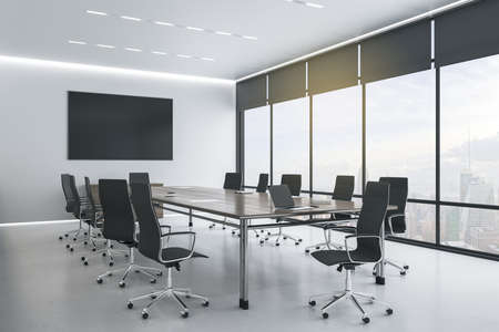 Blank black tv screen on white wall in modern conference room with stylish furniture and city view....