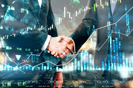 Business agreement concept with businessmen handshaking and forex chart diagram with financial...