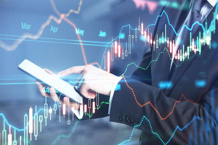 Online trading concept with businessman using smartphone and digital display with forex chart...