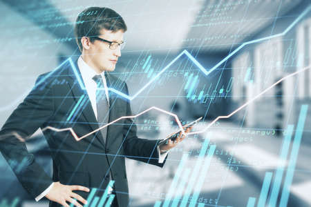 Business trading analysis concept with businessman looking at laptop and digital screen with forex...