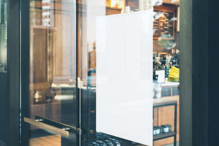 Blank white sign on glass door before cafe entrance. Mockupの写真素材