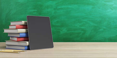 Online education concept with stack of books and digital tablet empty black screen on wooden table at green chalk board background. 3D rendering, mockupの写真素材