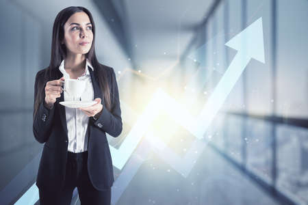 Ambition and leadership concept with satisfied businesswoman with coffee cup and digital glowing arrow up on background, double exposureの写真素材