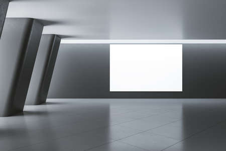 Blank glowing screen on dark wall in empty modern exhibition hall with big columns and ceramic tiles...