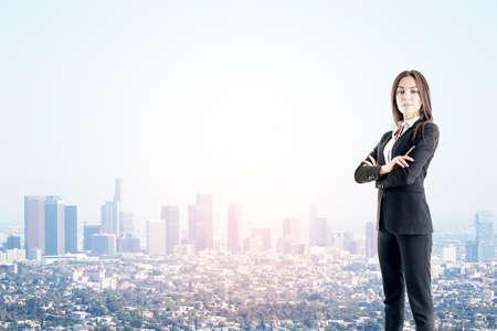 Succes concept with confident businesswoman on megapolis city backgroundの写真素材