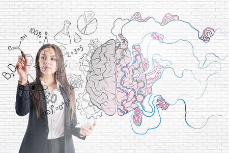 Brainstorming concept with businesswoman painting by pen illustration of human brain on glass screen...