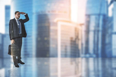 Looking into the future concept with businessman on glossy surface and sunset city skyscrapers with copyspace. Mockup, double exposureの写真素材