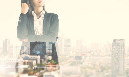 Thinking and question concept with pensive businesswoman and abstract city on background with copyspace. Mock up, double exposureの写真素材