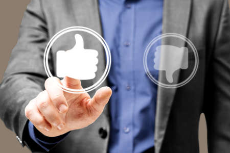 Businessman touches the upvoting hand icon, feedback concept