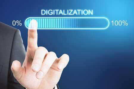 Digital transformation concept with businessman hand on virtual interface with digitalization word and loading bar elementの写真素材