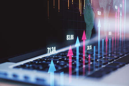 Global business and technology concept with laptop keyboard and digital financial arrows up. Double exposureの写真素材