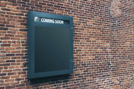 Blank black poster coming soon on old brick wall, side viewの写真素材
