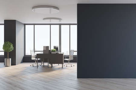 Blank black wall in spacious office hall with city view from big window, wooden tables and floor, tree in a metallic flowerpot and stylish lamps on top. 3D rendering, mockupの写真素材