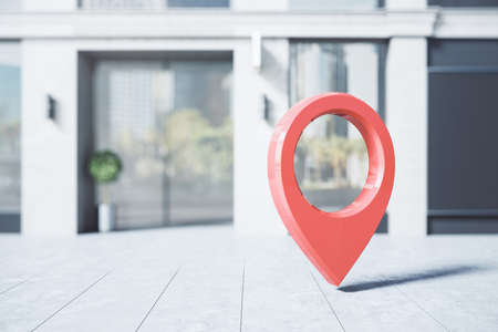 Navigation concept with big red pinpoint on sunny street before modern building entrance. 3D renderingの写真素材