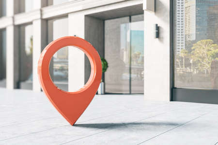Geo location concept with big red pinpoint on the street near trade center entrance. 3D renderingの写真素材