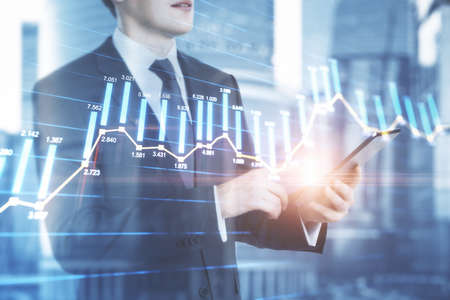 Entrepreneur counting the trading bar charts on the background with city view, market and analysis...